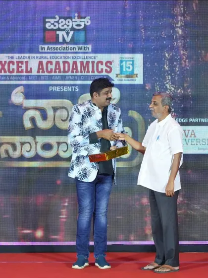 Shaking hands with an organizer at the Public TV and Excel Acadamics event. It was a well-organized program celebrating rural education.