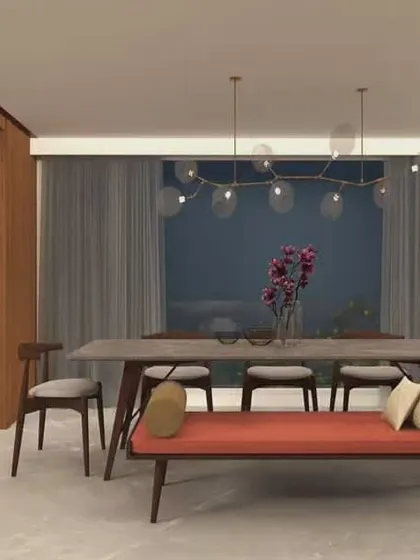 This dining area from our Mysore residence project combines modern furniture with subtle traditional elements. The bench seating is a great way to create a more casual and communal dining experience, while the pendant lights add a contemporary touch.