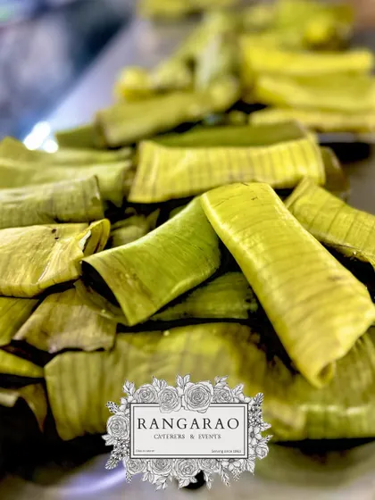 A stack of sweets steamed in banana leaves. This method of cooking infuses the dessert with a subtle, natural aroma, a hallmark of traditional South Indian cooking.