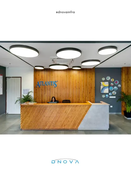 The reception area for Atlantis in Noida sets a professional and welcoming tone. My general contracting team ensured a flawless execution of the design, from the slatted wood paneling and geometric desk to the integrated halo lighting, creating a strong first impression.