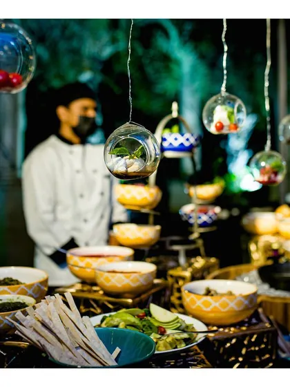 Our innovative hanging Burrata Bar, where fresh burrata is served with a variety of toppings and salads from a visually stunning setup.