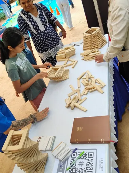 The workshop floor is a dynamic space of interaction. Children, parents, and mentors all come together, sharing ideas and learning from one another. This collaborative environment is where some of the best building and bonding happens.