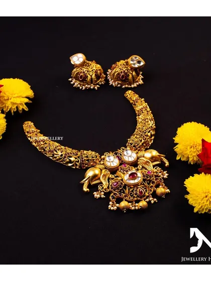 A unique crescent-shaped necklace with elephant motifs. This is a beautiful and artistic piece for someone looking for something different.