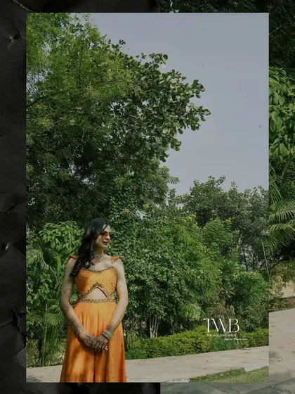 A wide shot of the bride against a backdrop of lush greenery. This photo captures the beauty of the natural surroundings at her destination haldi ceremony.