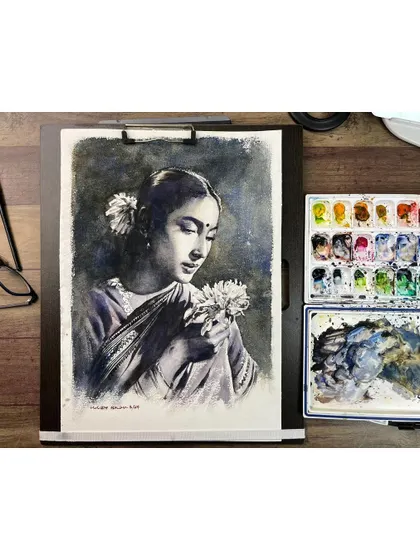 The Nutan portrait with flowers, shown on my easel next to my palette. This gives a sense of my workspace and the tools I use.
