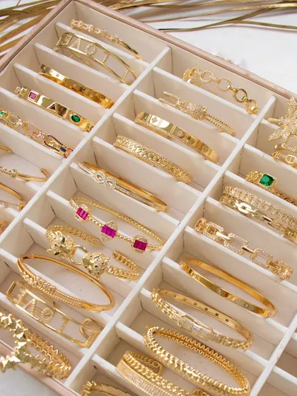 My arm candy collection. A beautiful shot of a jewellery box filled with my cuff bangles, from emerald and ruby to cheetah and love designs.