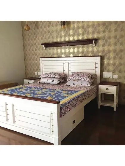 A bedroom featuring a farmhouse-style bed with a white frame and wood accents, complete with our "Box-on-Wheels" under-bed storage.