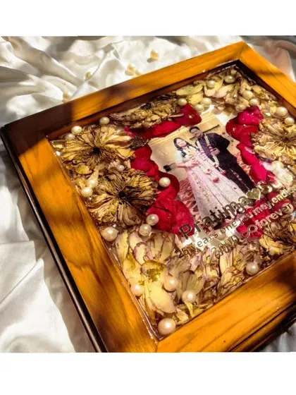 A full shot of the 25th-anniversary keepsake, a beautiful square frame that perfectly balances photos, flowers, and personalized text.