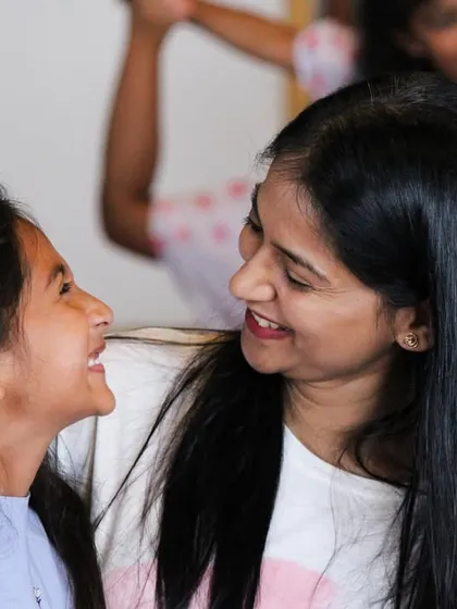 A quiet, happy moment shared between a mother and daughter. It's these small connections that build our strong and supportive community.