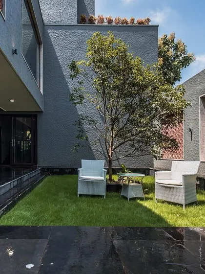 A quiet seating nook nestled in a private courtyard. This space offers a peaceful retreat, showcasing the balance between open social areas and intimate corners.