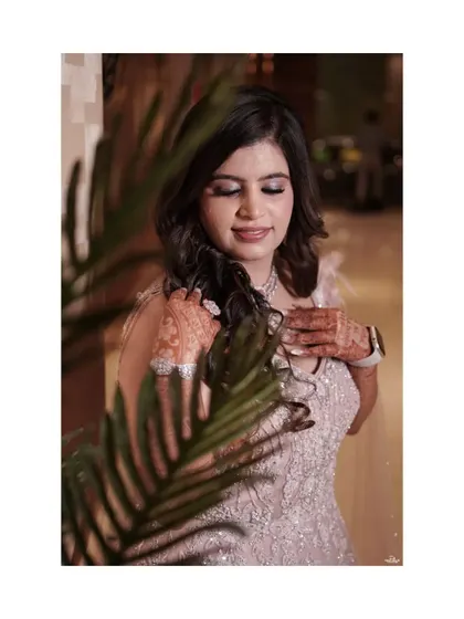 A peeking shot of the bride through foliage, adding a touch of mystery and artistry to her engagement portrait.