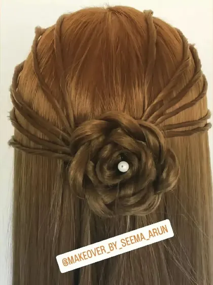 This half-up, half-down hairstyle features a beautifully crafted rose made from the hair itself. It's a romantic and detailed look, perfect for an engagement or pre-wedding photoshoot.