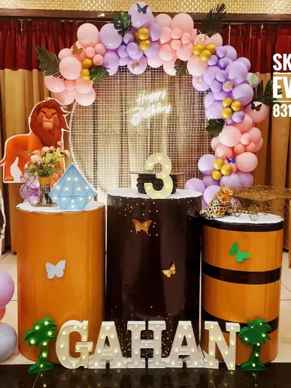 A jungle theme with a unique twist for Gahan's third birthday. I combined lion cutouts with a pastel purple and pink balloon arch, showing how I can customize any theme to your preferred color scheme.
