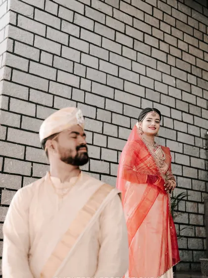 A creative shot using focus to draw attention to the bride in the background while the groom is softly blurred in the foreground.