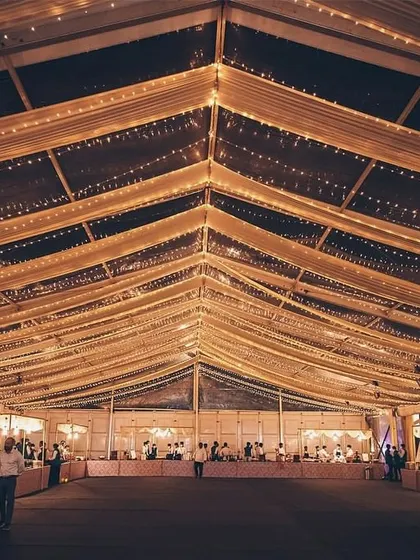 A wide shot of a grand event hall with long buffet tables.