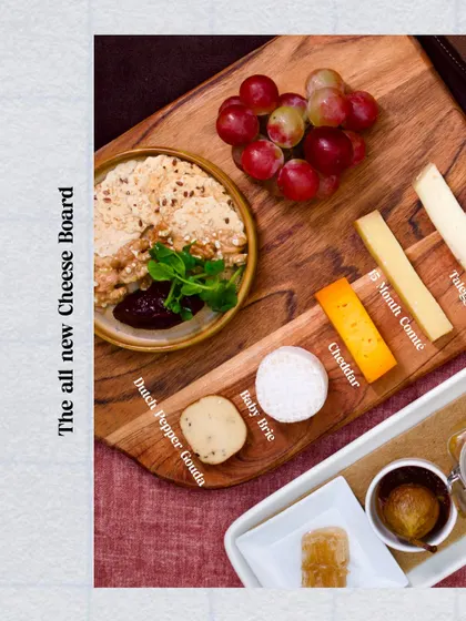 Our all-new Cheese Board, a celebration of artisanal cheese. We feature a curated selection including Dutch Pepper Gouda, 15-Month Comte, and a beautiful Baby Brie from our friends at Begum Victoria.