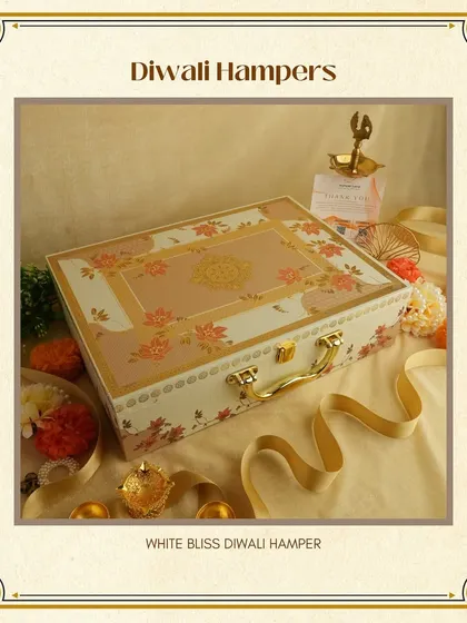 The "White Bliss" Diwali Hamper features a beautiful floral-printed suitcase box. Its light and elegant design makes it a refreshing and graceful gift option.