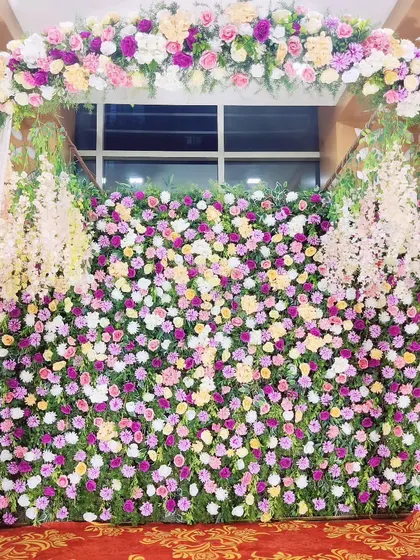 For a Ganapati festival or pooja, I created this stunning backdrop made entirely of real flowers. The dense wall of colorful carnations and roses provides a vibrant and fragrant setting for the deity.
