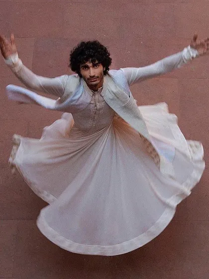 A dynamic shot of a groom's angrakha-style kurta, captured in motion. This look, inspired by Sufi dancers, is for the groom who wants something artistic and unique.