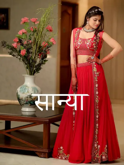 A full-length shot of Sanya, her name elegantly overlaid, showcasing her beautiful red embroidered outfit.