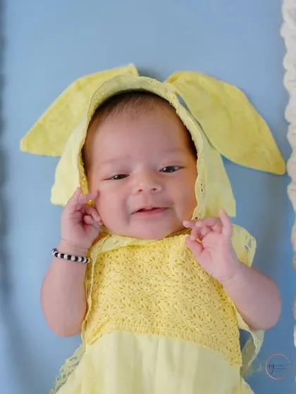 A sweet, sleepy smile from this newborn bunny. Close-up shots like this capture the delicate features and expressions of a new baby.