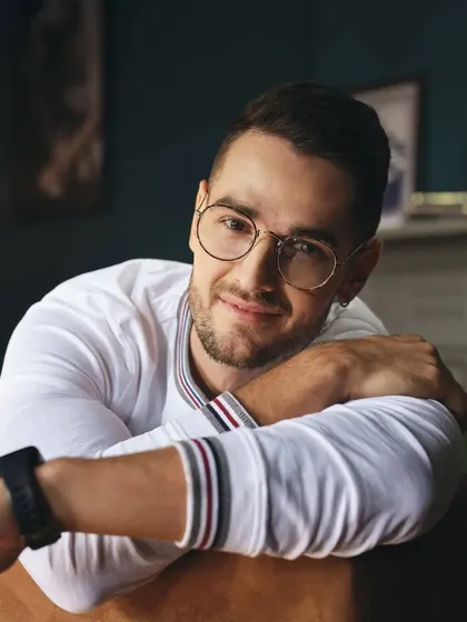 A close-up portrait from a Basics Life shoot. The simple white long-sleeve tee with striped collar detail is a subtle but stylish piece that shows how we focus on small details to elevate a look.
