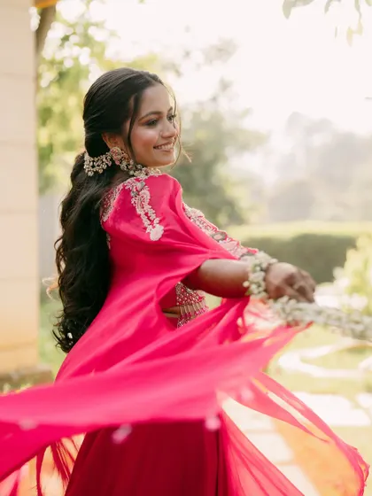 A Haldi ceremony is all about joy and vibrancy. This bride is twirling with happiness, and her fresh makeup look with floral jewelry was designed to match that bright, playful energy.