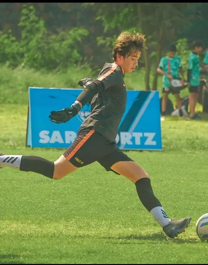 Our goalkeeper makes a clean kick to clear the ball during a U13 Pride Cup match.