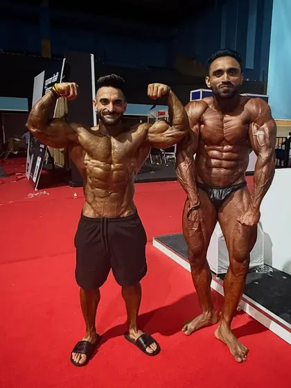 Another shot with a fellow champion, both of us showcasing our hard-earned physiques.