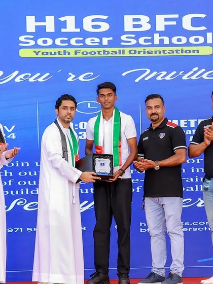 A BFC youth player receives an award at the H16 BFC Soccer School launch event in the UAE, a proud moment for our player pathway.