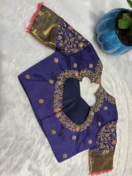 A deep purple blouse with a heart-shaped back cutout, framed with heavy floral embroidery.