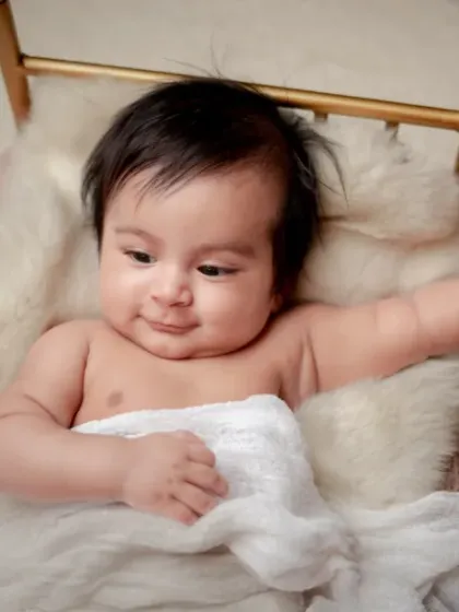 A smile that melts hearts. This older baby is so expressive, and I love capturing these happy moments in a simple, beautiful setup.