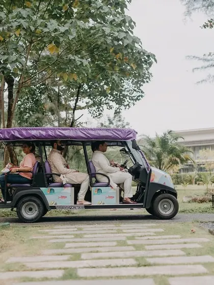 A fun, candid shot of the wedding party moving around the resort in a golf cart. These are the small, in-between moments that add character to the wedding album.