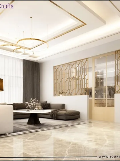 A luxurious living room featuring a grand false ceiling with gold accents, marble flooring, and a stylish geometric partition. This space is a testament to sophisticated contemporary design.