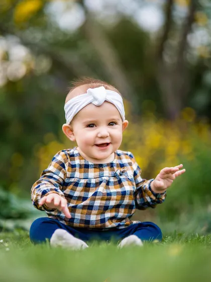 Capturing the simple, silly, and beautiful moments of childhood. This little one's happy expression and playful gesture make for an adorable portrait.