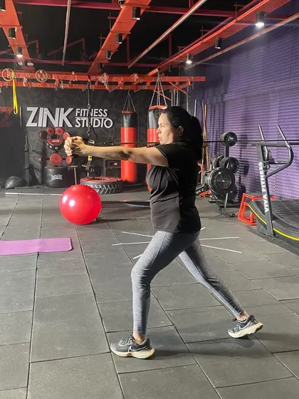 This client is performing a single-arm row with a resistance band, a great exercise for building back strength and improving posture, even with minimal equipment.