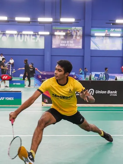 A player in a Padukone School of Badminton jersey stretches for a forehand shot. Our tournaments are a key competitive outlet for players from our own academies and across the country.