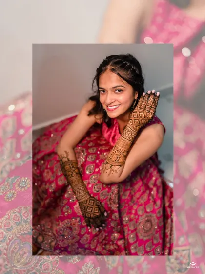 The bride proudly shows off her beautiful Mehendi design, a symbol of love and celebration.