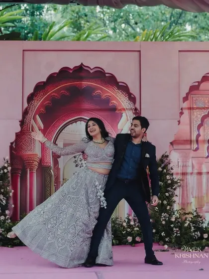 Amidst the grandeur of the Rajput palace-themed stage, the couple shares a playful dance. These are the candid, joyful moments that make a wedding celebration truly special.