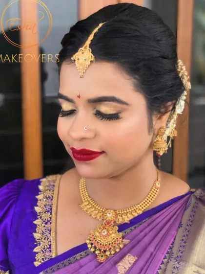 A bold and beautiful engagement look. This style features striking gold eyeshadow and a classic red lip, perfect for making a statement.
