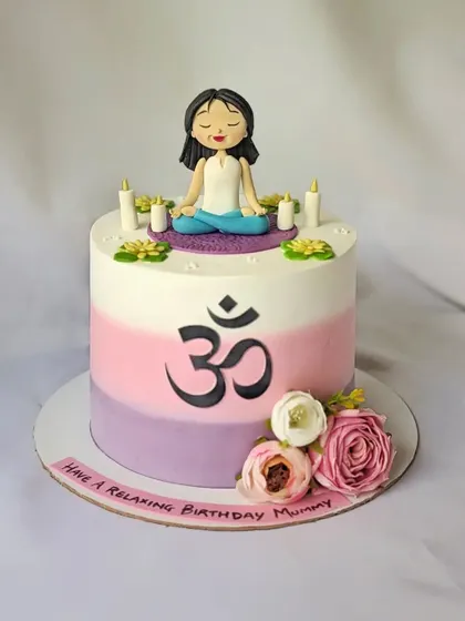 A relaxing yoga-themed cake for a mother's birthday. It features a figurine in a meditative pose, the Om symbol, and a peaceful ombre color scheme.