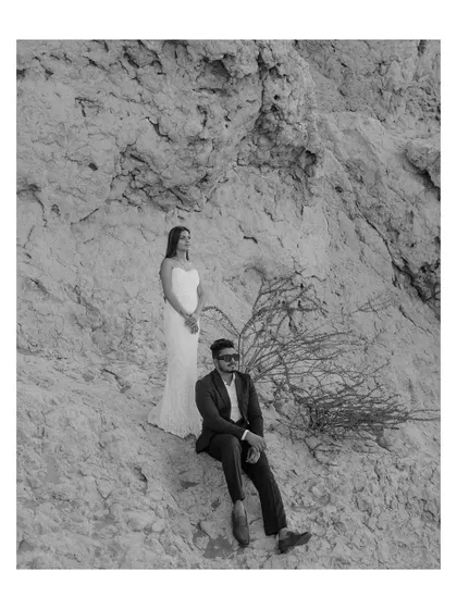 A minimalist black and white portrait set against the rocky textures of the Dubai landscape. The simple composition and timeless editing style put the focus entirely on the couple's presence and connection.