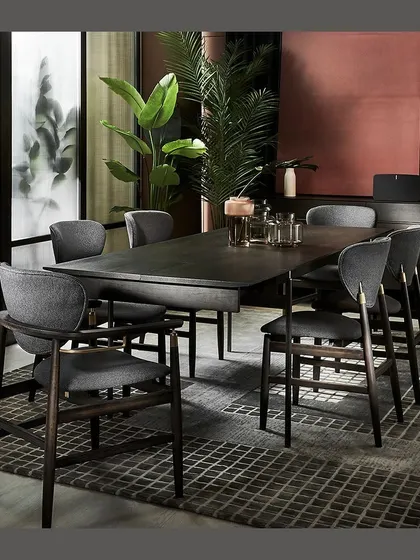 The Linate Dining Set, designed in a modern minimalist style. The elegant smoked oak, hints of brass, and understated gunmetal legs create a sophisticated atmosphere for any dining occasion.