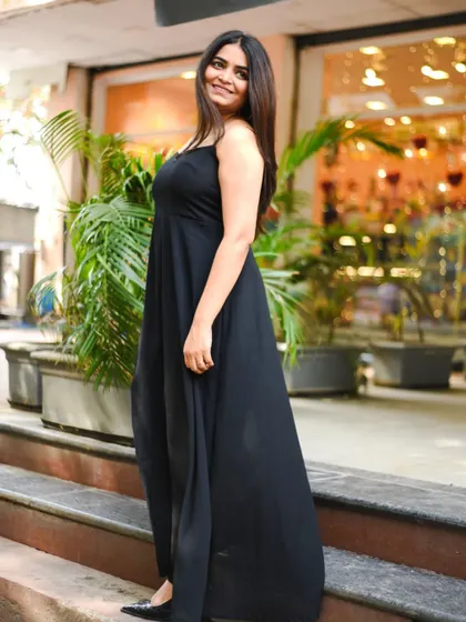 A full-length shot of a woman in a simple, elegant black dress. This type of portrait is timeless and versatile.