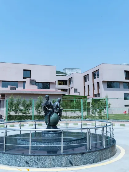 An outdoor sculpture at Konark Academy serves as a central landmark. This piece, depicting students reading on a globe, is situated within a roundabout and symbolizes the institution's commitment to global learning.