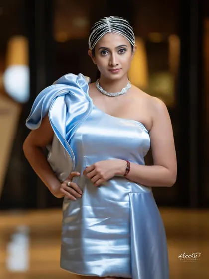 This portrait focuses on a unique, avant-garde look. The sculptural blue dress and intricate headpiece are the stars of the show, creating a high-fashion image that's both bold and artistic.