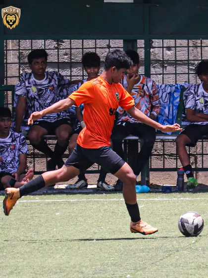 A player taking a shot during a match, showcasing the attacking intent we encourage.