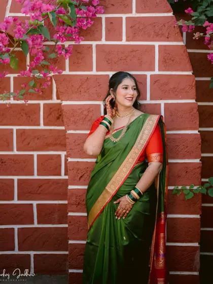 A beautiful portrait of the bride, Ankita, against a rustic brick wall during her engagement in Satara.