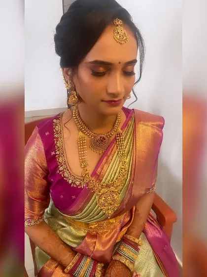 Priyanka's full engagement look. The soft makeup and elegant updo are the perfect complement to her beautiful pink and green silk saree.