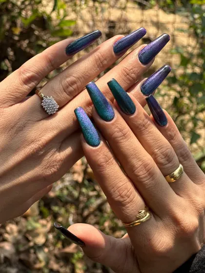 Another view of the long, coffin-shaped peacock nails, showing the full spectrum of color. This is a gel polish over acrylic extensions for maximum impact and durability.
